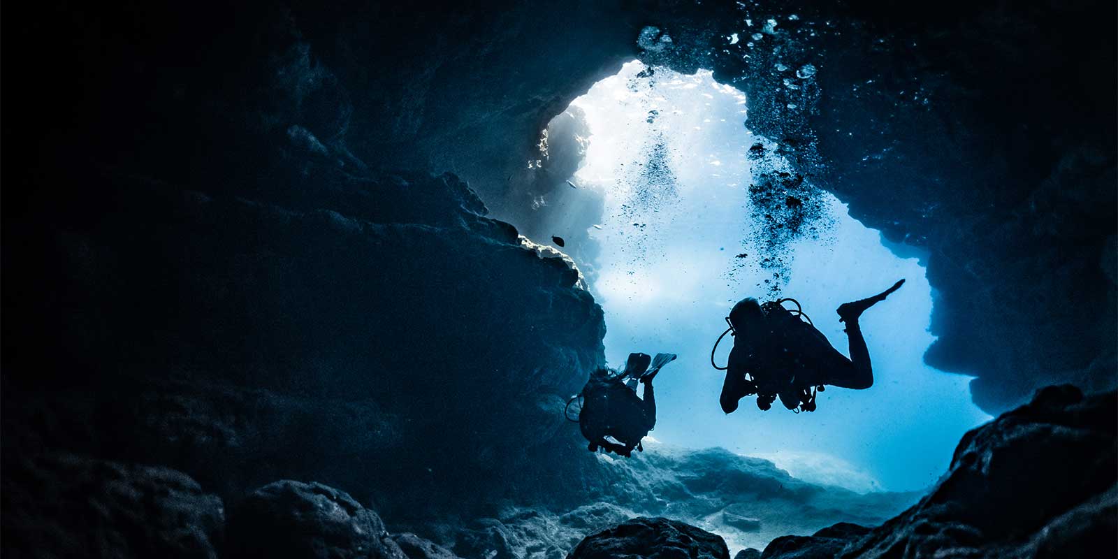 Divers exploring a cave in Malta