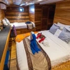 View of a deluxe stateroom with double bed in Komodo Aggressor, Indonesia.