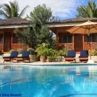Exterior of Magic Island Dive Resort, complete with pool and space to relax.