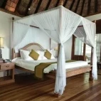 A Sunset Lagoon Villa bedroom, at Coco Palm Dhuni Kolhu Resort, Maldives