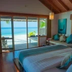 Beach villa bedroom at Kuredu Resort & Spa in the Maldives.