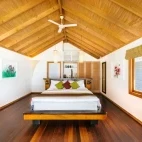 Beach villa bedroom at Kuredu Resort & Spa in the Maldives