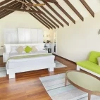 Deluxe beach villa bedroom at Kuredu Resort & Spa in the Maldives