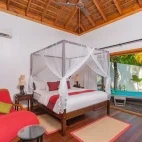 Private pool villa bedroom at Kuredu Resort & Spa in the Maldives.