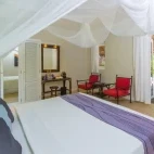 Garden bungalow bedroom at Kuredu Resort & Spa in the Maldives.