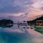 Sunset view by the pool at Lily Beach Resort & Spa, Maldives.