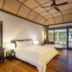 Example of a beach villa bedroom at Lily Beach Resort & Spa, Maldives.