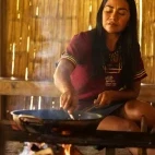 Woman making chocolate at Napo Cultural Centre Lodge.