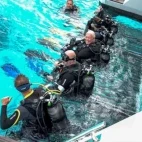 Divers on the lift platform, on Aqua Tiki III, French Polynesia.