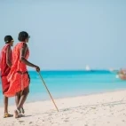 Masai warriors walking on a beach in Zanzibar, Tanzania