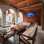 Communal lounge, with views out to the courtyard with swimming pool at Villa Carey, Mexico