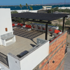 Aerial view of the communal rooftop terrace at Villa Carey, complete with bar area.