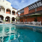 The swimming pool with view of Villa Carey accommodation behind. Shaded seating area available poolside.