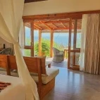 View of the deluxe bungalow at the resort, with stunning views of the decking and beyond, and a tea making area.