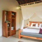 Bedroom area of the hillside bungalow at Alor Tanapi Dive Resort.