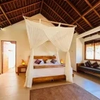 View of the bedroom in the oceanfront room at Alor Tanapi Dive Resort, Indonesia.