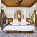 View of a premium bedroom in a hillside cottage at Murex Bangka, Indonesia.