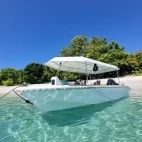 Tompotika Dive Lodge boat by the beach.