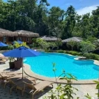 The pool and sun lounge area at Magic Oceans Resort, Philippines.