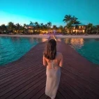 Guest walking along the pier at Chabil Mar Villas, Belize.