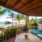 A seafront villa verandah looking out to the beach, at Chabil Mar Villas, Belize.