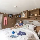 Guest enjoying the balcony suite cabin, with optional double or twin bed set-up.