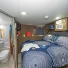 The deluxe stateroom cabin with double bed setup. This room is flexible, offering both double and twin bed layout.