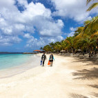 Divers walking along the beach at Harbour Village Beach Club in Bonaire