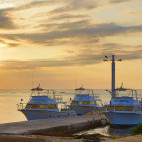 Boats docked at sunset at Brac Reef Beach Resort in Grand Cayman, the Cayman Islands