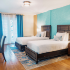 Standard room in a twin bed setup at Manta Lodge in Tobago