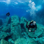 Pair of divers exploring Malta's underwater diving sites.