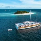 Aerial view of the ship alongside an island in the Maldives.