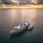 Sunset aerial view of the Nautilus Two liveaboard vessel, in the Maldives.