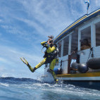 Diver jumping from a dhoni in the Maldives