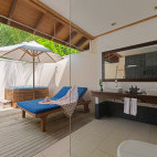 Jacuzzi beach villa bathroom at Vilamendhoo Island Resort, Maldives.