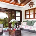 View of a lounge area and balcony at Wooden House Lodge, Isabela Island, Galapagos
