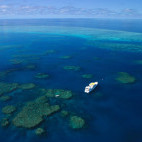 Aerial shot of Spirit of Freedom liveaboard sailing around Great Barrier Reef
