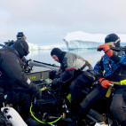 Divers on Zodiacs in Antarctica.