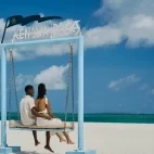 Couple on the ocean gate bench at Kendwa Rocks Beach Hotel, Zanzibar