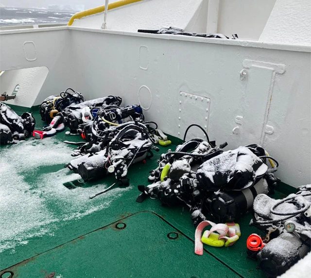 Dive kit on the deck of Plancius, covered in snow in Antarctica.