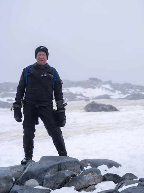 Male in his dive kit preparing for diving in Antarctica
