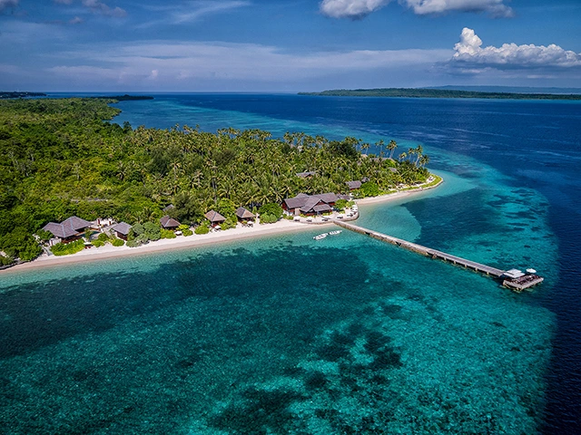 Aerial of the house reef & Wakatobi Dive Resort in Indonesia.