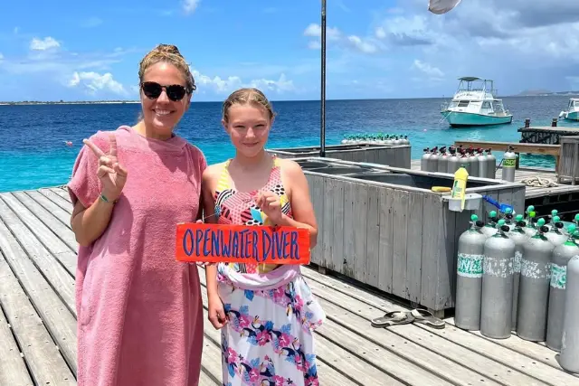 Girl and Instructor posing as she has completed her PADI Junior Open Water course