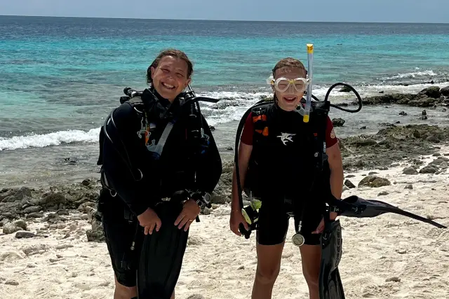 Mother and daughter ready to dive in their diving gear