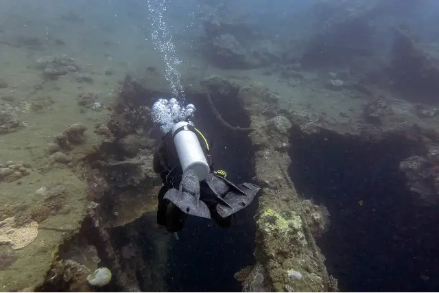Diver venturing into the shipwreck of SS President Coolidge, Vanuatu.