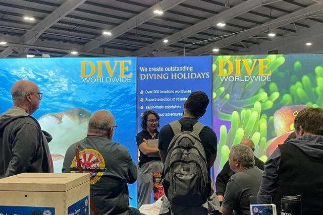Team member Jo talking to stand visitors at the Go Diving show.