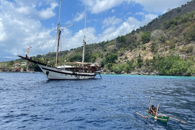 Kids playing in a boat by the Raja Laut, Alor, Indonesia.